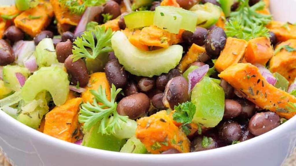 A closeup of a white bowl filled with Black Bean Roasted Sweet Potato Salad.