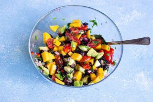 The black bean salad mixed together in a mixing bowl.
