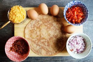 All the ingredients for this Breakfast Quesadilla Recipe gathered on a cutting board.