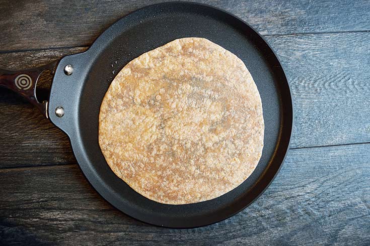 A tortilla on a flat skillet. (A crepe pan)