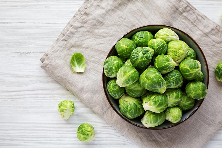 A bowl of Brussels sprouts in a bowl from overhead.