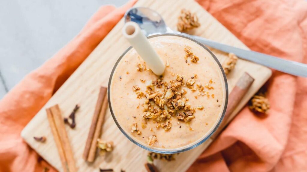 An overhead view of a glass filled with butternut squash smoothie.