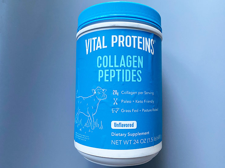 A blue and white container of collagen peptides on a blue background.
