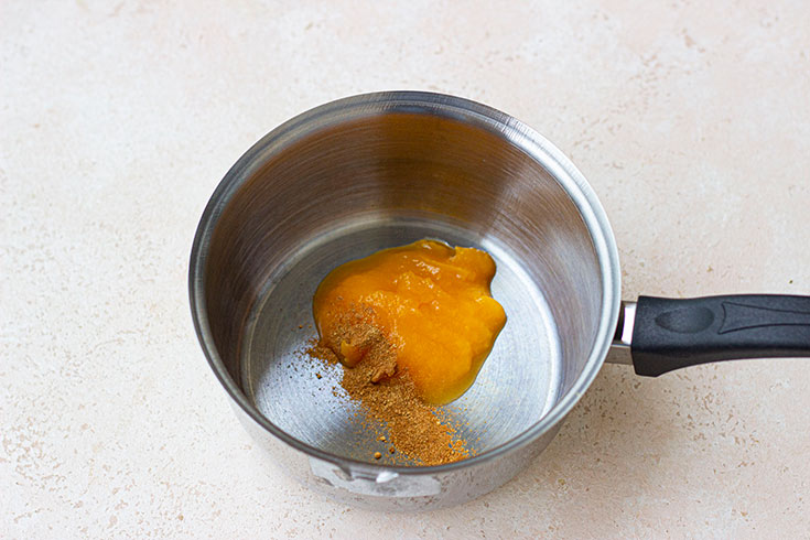 Pumpkin puree and pumpkin pie spice in a pot.