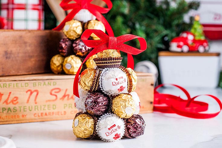 A homemade Ferrero Rocher Christmas Tree sitting on a countertop.