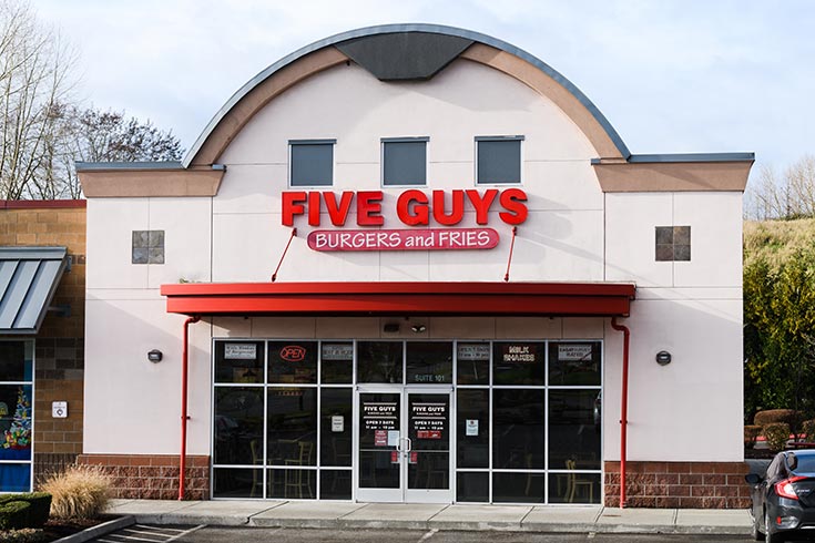 The front of a Five Guys restaurant.