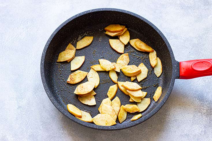 Apple pieces in a skillet.