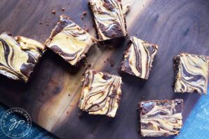 An overhead view of Peanut Butter Swirl Brownies sitting on a cutting board.