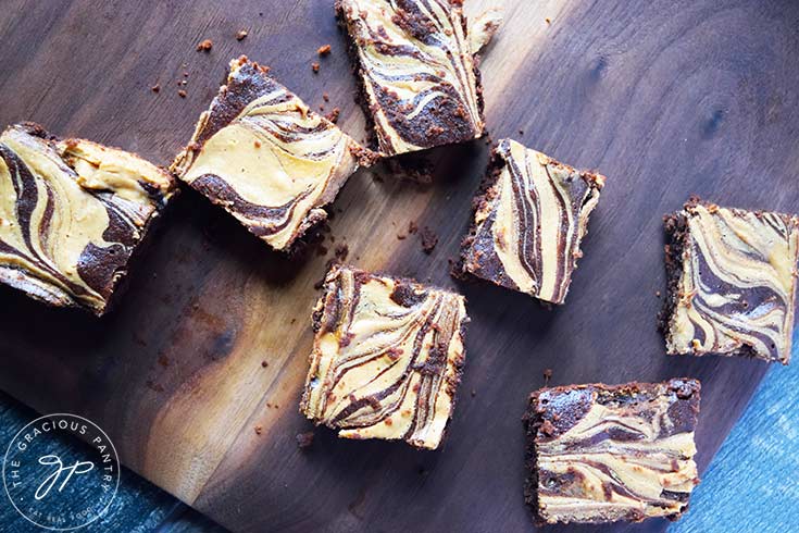 And overhead view of Peanut Butter Swirl Brownies sitting on a cutting board.