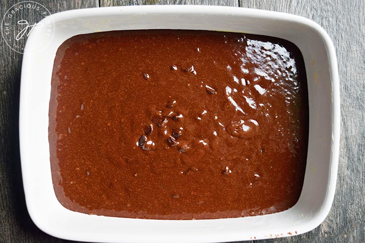 Peanut Butter Swirl Brownie batter settled in a buttered baking dish.