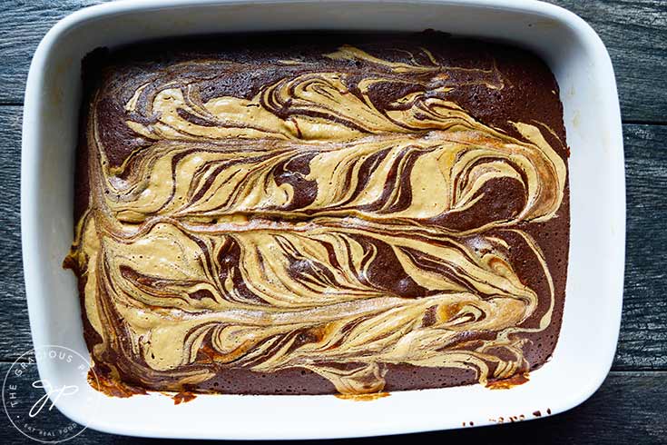 Baked Peanut Butter Swirl Brownies cooling in a baking dish.
