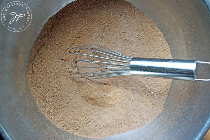 Dry ingredients mixed together in a mixing bowl with a whisk.