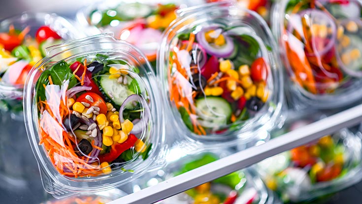 Prepared salads on a store shelf.