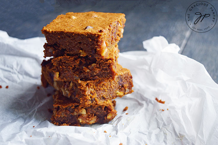 A stack of Pumpkin Blondies on wrinkled parchment paper.