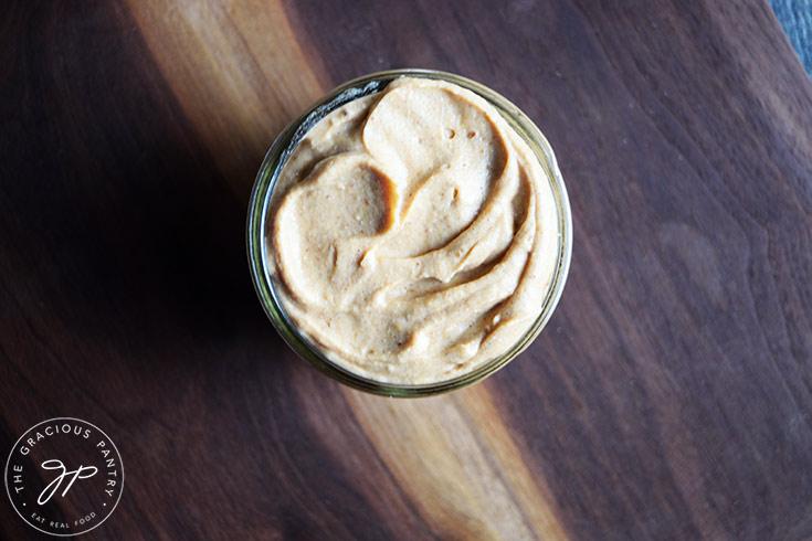 Pumpkin cream cheese transferred to a glass jar for storage.