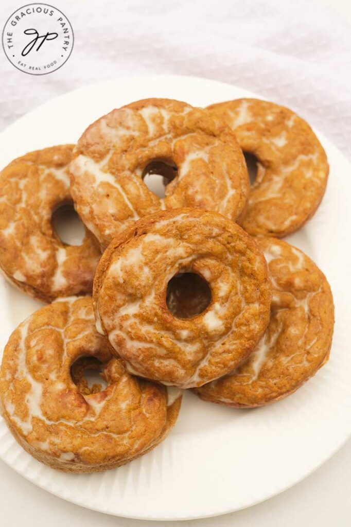 A white plate holds six Pumpkin Donuts.