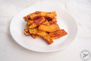 Pumpkin Fries on a white plate, on a white background.