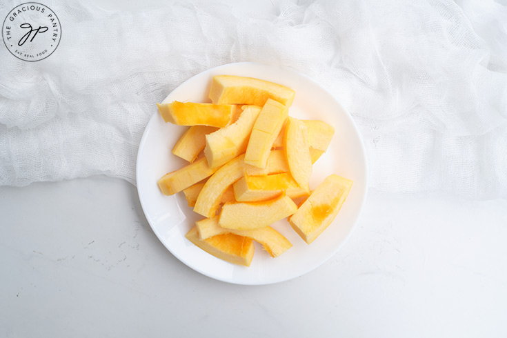 Raw Pumpkin Fries on a white plate.