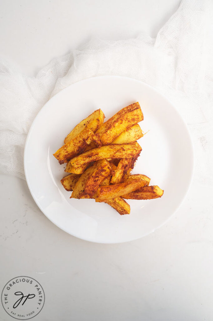 An overhead view of a white plate filled with Pumpkin Fries.