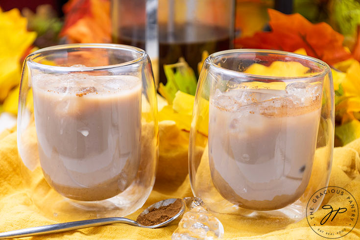 Two small espresso cups filled with Iced Pumpkin Spiced Latte.