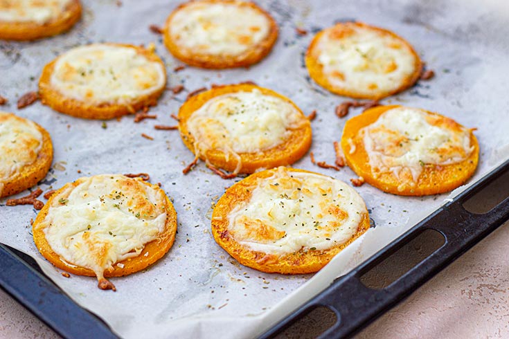 Melted cheese on squash slices after baking.