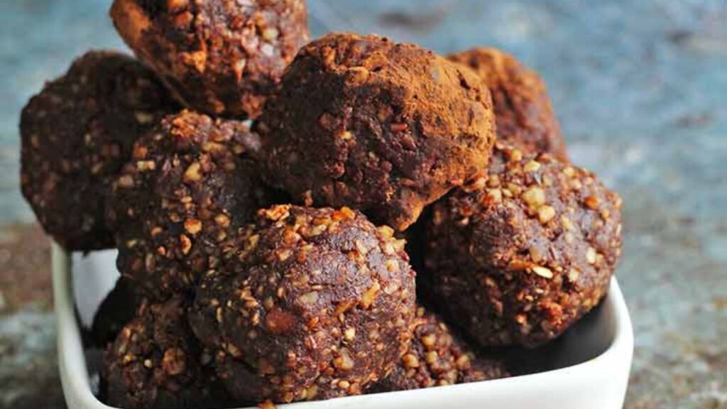 A white dish filled with rum balls.