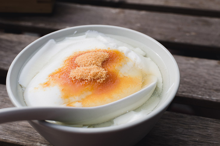 A white bowl filled with tofu pudding.