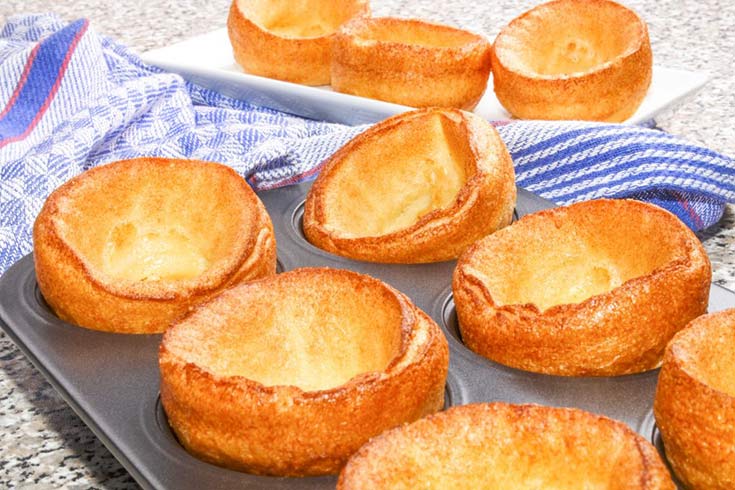 Yorkshire puddings in a muffin pan on a table.