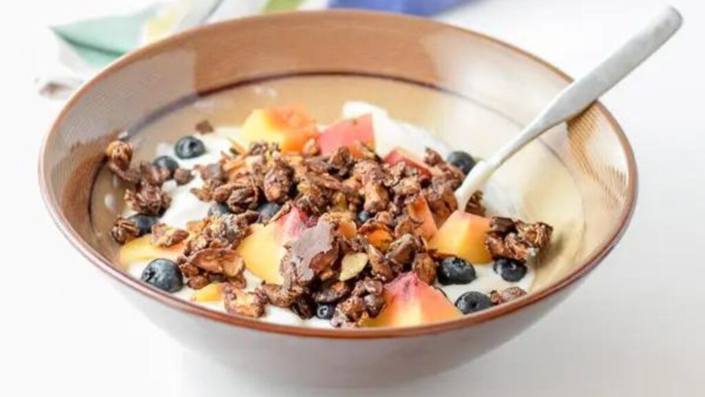 A bowl half filled with easy delicious chocolate granola clusters.