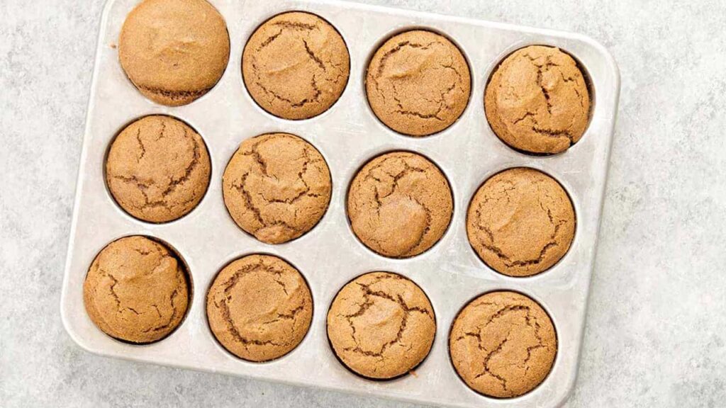 Gingerbread muffins in a muffin pan.