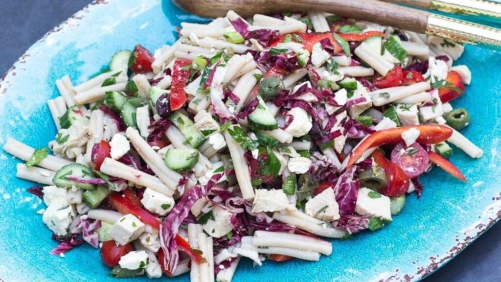 A platter holding low FODMAP Mediterranean pasta salad.