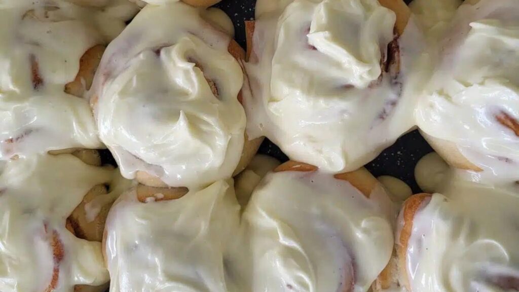 An overhead view of frosted cinnamon rolls.