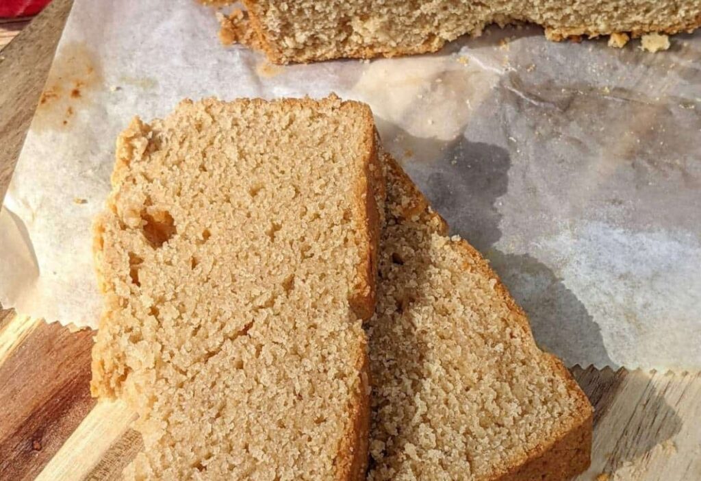 Two slices of peanut butter bread on a cutting board.