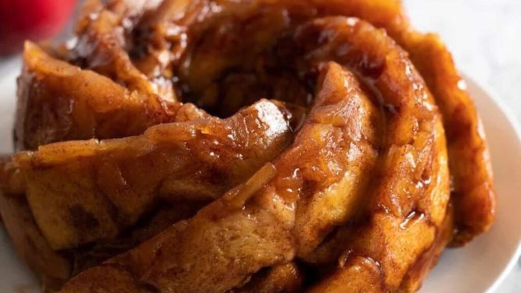 A closeup of apple monkey bread on a white platter.