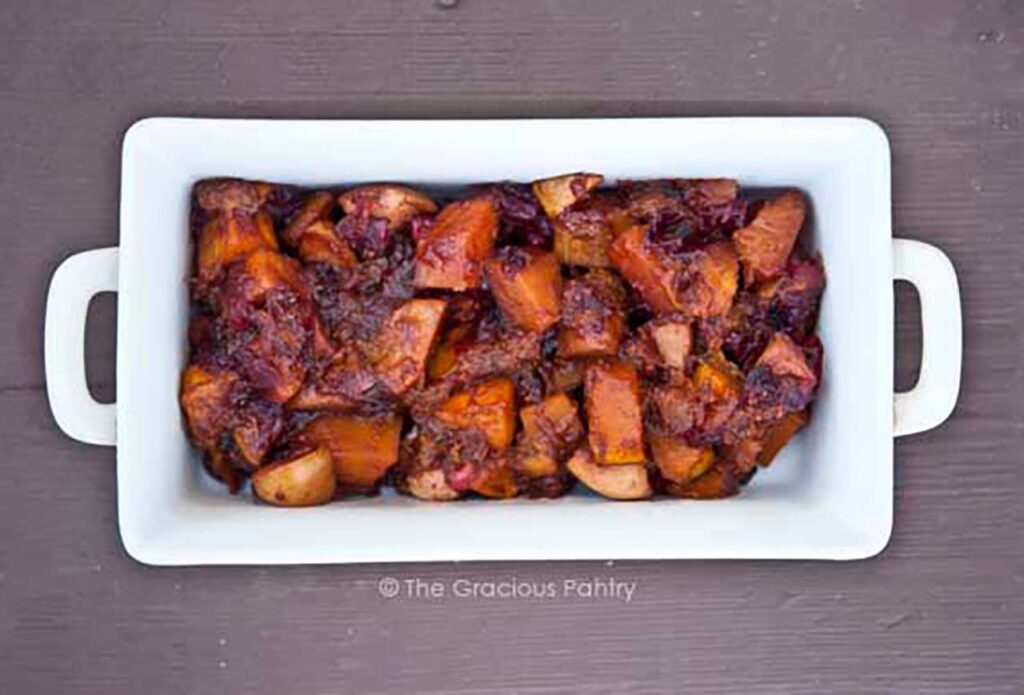 A white casserole dish filled with cranberry butternut bake.