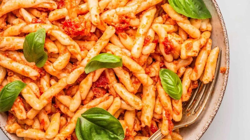 A closeup of casarecce pasta on a plate.