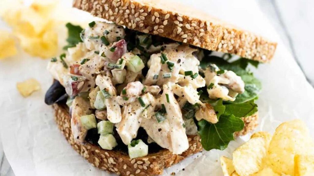 A chicken sandwich sitting on a white surface.