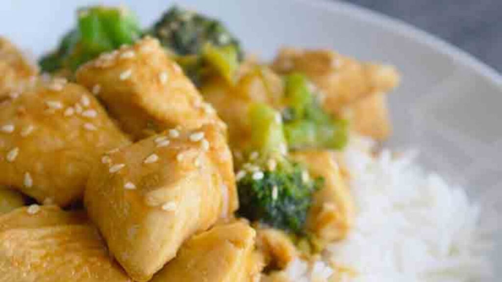 A bowl of this Easy Teriyaki Chicken Recipe served over a bed of rice.