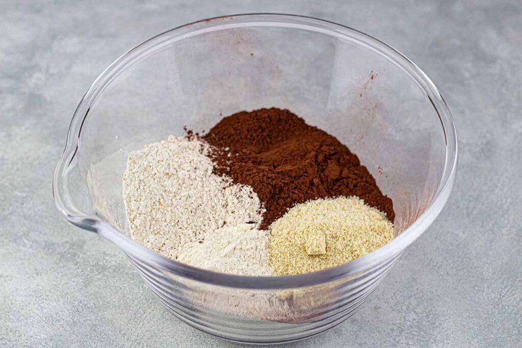 Chocolate Christmas Cake Recipe dry ingredients in a glass mixing bowl.