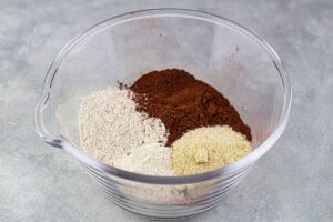 Chocolate Christmas Cake Recipe dry ingredients in a glass mixing bowl.