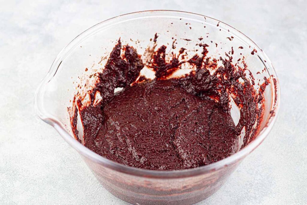 Chocolate Christmas Cake batter in a glass mixing bowl.