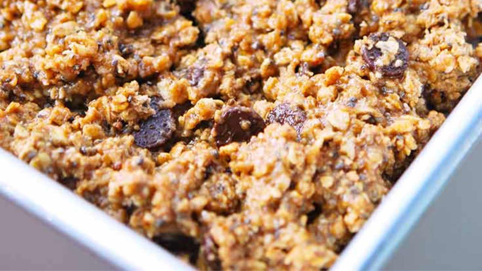 A tray filled with Chocolate Chip Protein Bar batter sits ready to go into the oven for baking.