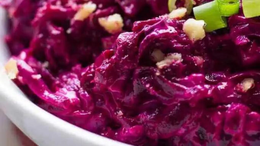 A white bowl filled with cold beet salad.