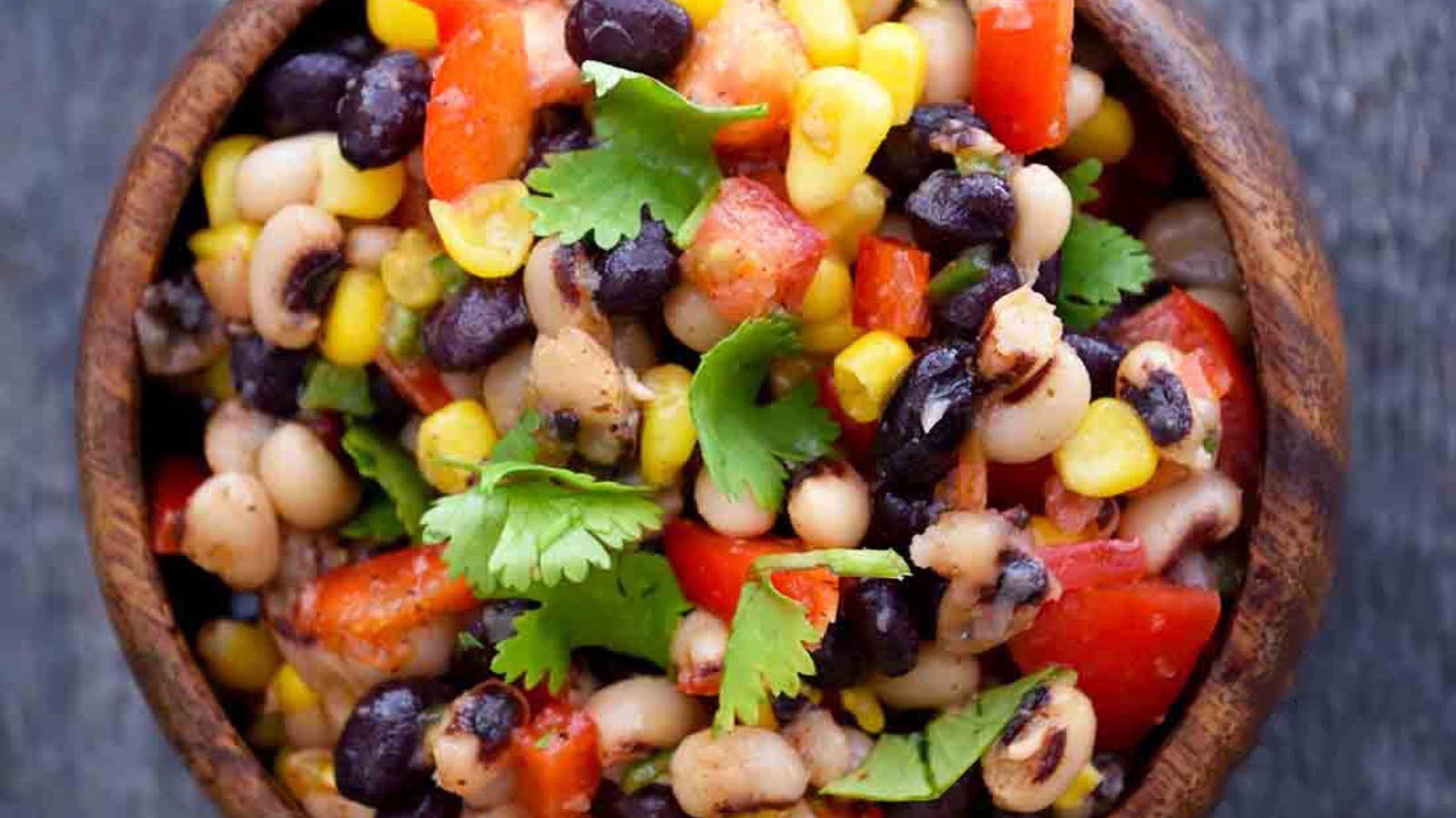 And overhead shot looking down into a wooden bowl filled with this Cowboy Caviar Recipe.