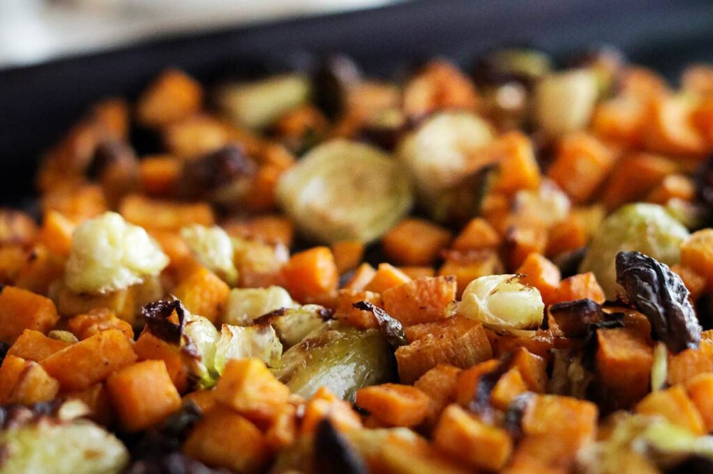 Roasted vegetables on a sheet pan after roasting.