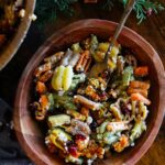 An overhead view of a wooden bowl filled with Fall Harvest Pasta Salad.