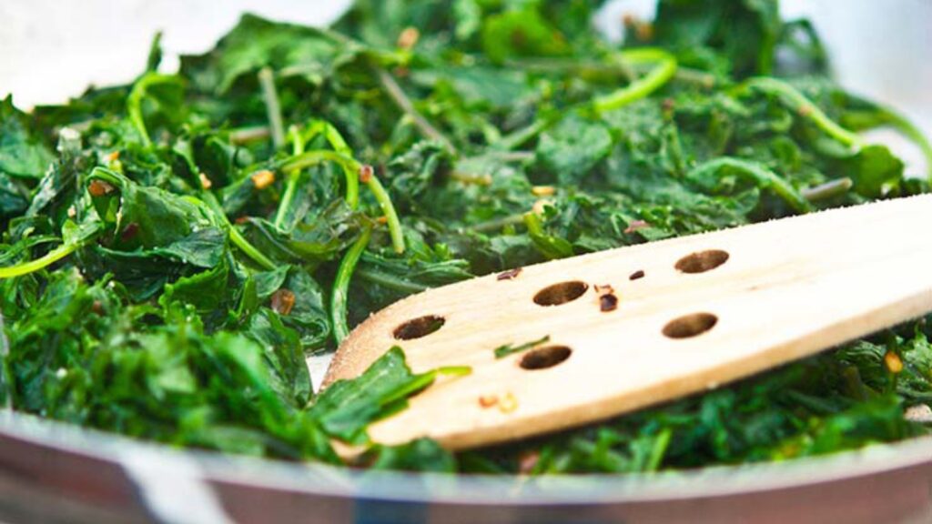 A skillet filled with just-cooked baby kale.