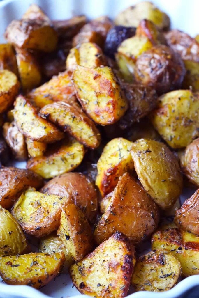 A closeup of Garlic Lemon Potatoes in a white dish.