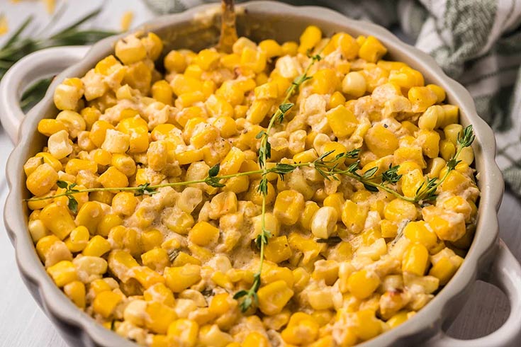 A casserole dish filled with gouda and cream cheese corn.