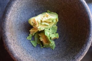 An avocado in a mortar.